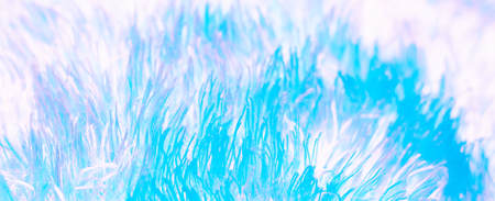 Airy soft fluffy feathers in haze background. Natural texture pattern of bird detail down feathers in neon pastel colors.の写真素材