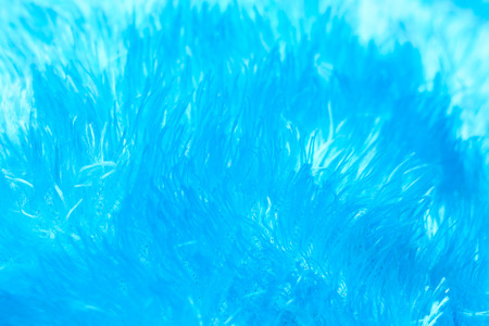 Airy soft fluffy feathers in haze background. Natural texture pattern of bird detail down feathers in neon pastel colors.の写真素材