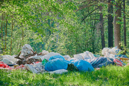 Dirty green messy nature landscape with pile of waste garbage.の写真素材