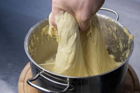 the man kneads the yeast dough for baking bread. fermented dough.の写真素材
