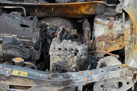 partially burned down car after the fire, parts of body the burned handles of doors and the burst glasses, picture not from pleasant, the insured car after the fireの写真素材