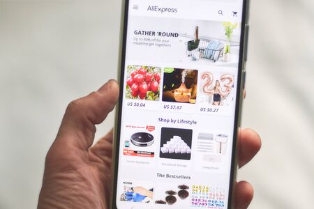 CHIANG MAI, THAILAND - Mar 18,2018: Man hands holding HUAWEI with alibaba apps on screen.