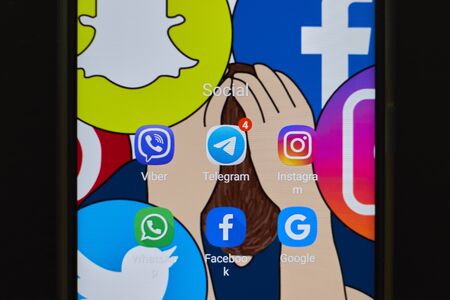 CHIANG MAI, THAILAND - Mar. 24,2019: Man holding Xiaomi Mi Mix 3 with icons of social media on the...