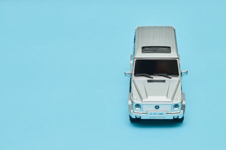 silver male toy car on a blue background. copy space, february 14 for valentines day, mock up for holidayの写真素材