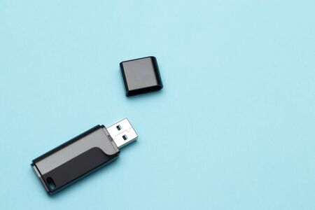isolate flash drive on a blue background. electronics concept. memory for transferring files and information. flash card.の写真素材