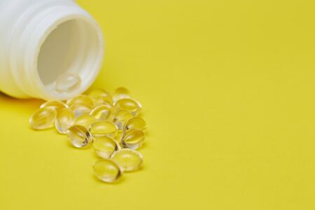 Assorted pharmaceutical medicine pills, tablets and capsules and bottle on blue background. Copy space for textの写真素材