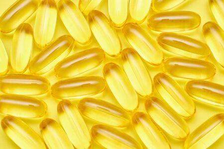 Assorted pharmaceutical medicine pills, tablets and capsules and bottle on blue background. Copy...