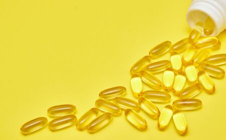 Assorted pharmaceutical medicine pills, tablets and capsules and bottle on blue background. Copy space for textの写真素材
