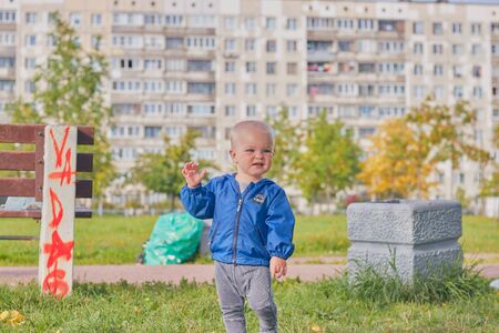 Cute little blond boy is walking in the clear summer weather in the park. The concept of childhood children and family relationships.のeditorial素材