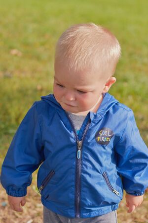 St. Petersburg, Russia, August 5, 2019.Cute little blond boy is walking in the clear summer weather in the park. The concept of childhood children and family relationships. child protection.のeditorial素材