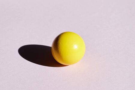 Yellow tennis ball on green red triangle intersection. Abstract colorful graphic geometric background. Business innovation technology modern arts architecture concept. Creative flat lay copy spaceの写真素材