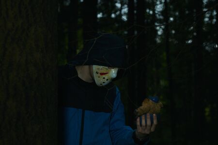Miami, Florida USA - May 3, 2019. Friday 13th hockey mask of Jason Voorhees. Halloween concept. day of death. man in a jason mask on a black background.のeditorial素材