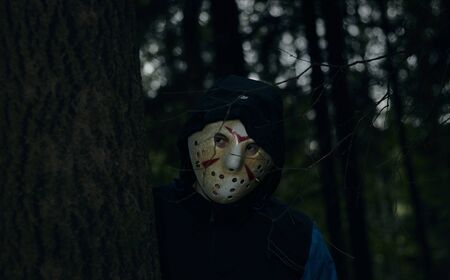 Miami, Florida USA - May 3, 2019. Friday 13th hockey mask of Jason Voorhees. Halloween concept. day of death. man in a jason mask on a black background.のeditorial素材