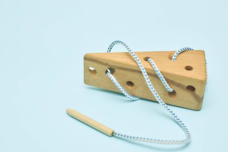 Children educational toy in the form of cheese on a blue