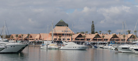 Portugal, Vilamoura, 02.01.2023. Marina de Vilamoura. Yachts standing at the pier on a cloudy day. Expensive yachts.のeditorial素材