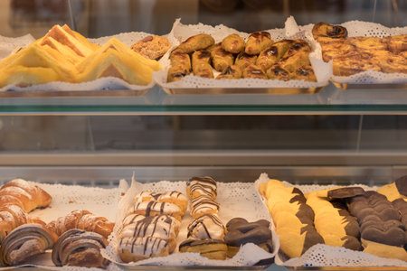 Chocolate croissants and other pastries on the counter in the pastry shop. Fresh pastries. Sweet desserts. sale of confectionery.の写真素材