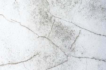 Background of white wall with cracks, texture, wall, concrete, can be used as a background. Fragment...