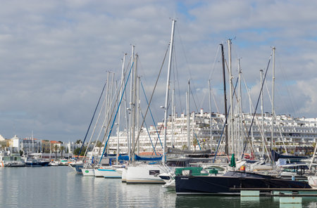 Portugal, Vilamoura, 02.01.2023. Marina de Vilamoura. Yachts standing at the pier on a cloudy day. Expensive yachts.のeditorial素材