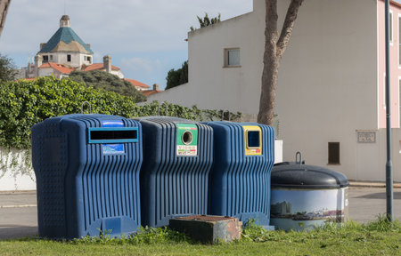 Portugal, Vilamoura, 02.01.2023. - Large recycling bins installed in the yard. separating trash from glass, paper, glass. Outdoor recycling bins. trash separation.のeditorial素材