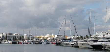 Portugal, Vilamoura, 02.01.2023. Marina de Vilamoura. Yachts standing at the pier on a cloudy day. Expensive yachts.のeditorial素材