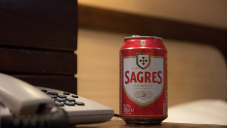 Portugal, Vilamoura, 02.01.2023. an iron can of sagres beer stands on the table next to the landline, Portuguese beer.のeditorial素材