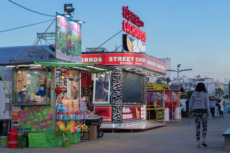 Portugal, Vilamoura, 02.01.2023. Commercial truck selling street food in a modern location near the sea. popcorn kiosk on the street.のeditorial素材
