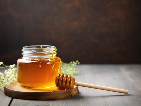 glass jar full of honey and dipper. natural, ecological, useful product. natural sweetness.の素材