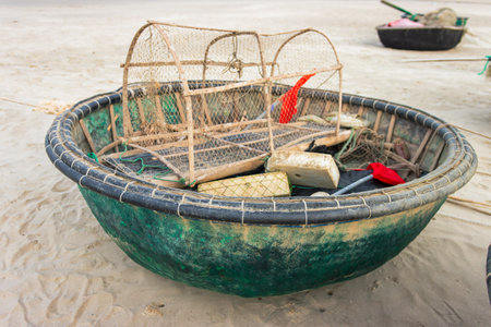 Round fishing boatsson the sandの写真素材