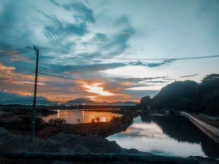 Sunset on the background of the river with an orange hue