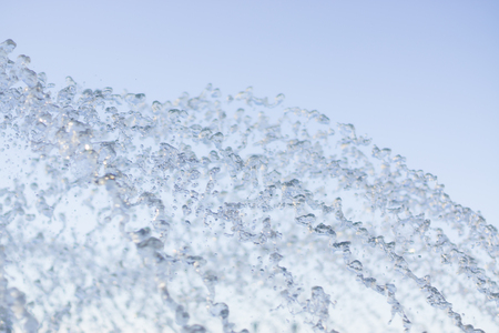 Splashes of water flying up and falling down, frozen motion, close shotの写真素材