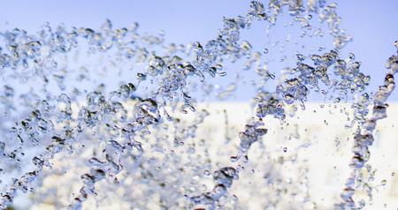 Splashes of water flying up and falling down, frozen motion, close shotの写真素材