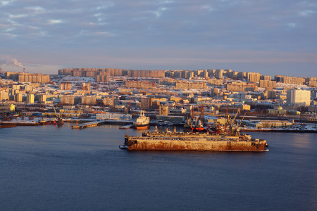 Panorama of the sea city at sunset, the old ship dock stands on the pier in the middle of the bay.の写真素材
