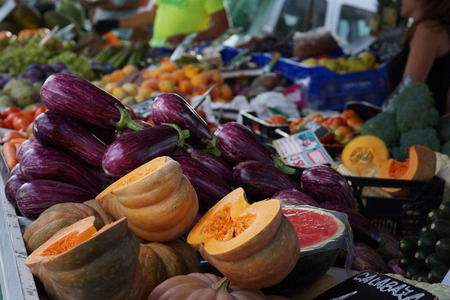 Pumpkin and zucchini on the counter in the vegetable market in Spain.の写真素材