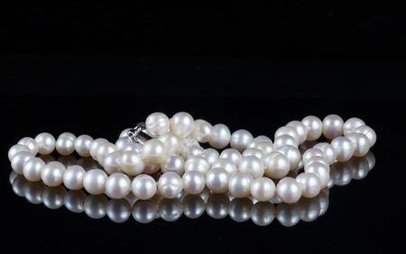 Beads of pearls on a black backgroundの写真素材