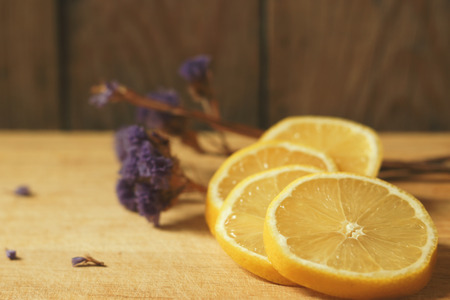 Lemon, cut into slices on a wooden tableの写真素材