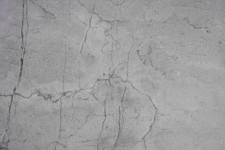 Background gray in stone, resembling concrete with cracks.の写真素材