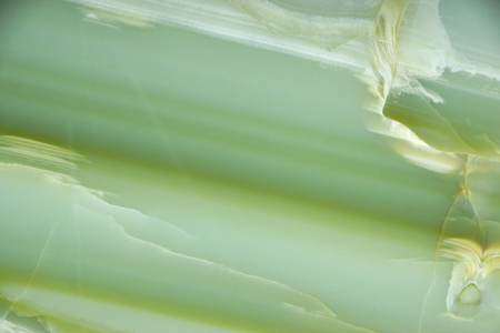 Fragment of natural polished Verde Onyx stone of green color with stripes and streaksの写真素材