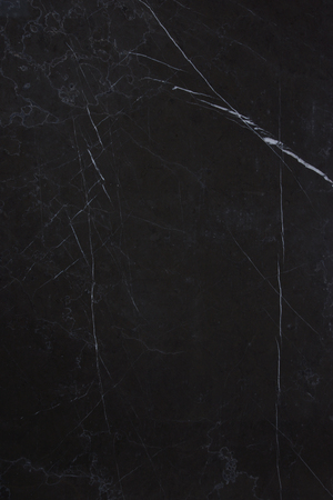 The texture of the natural stone is dark marble with patterns and white stripes, the stone is called Nero Marquina.の写真素材