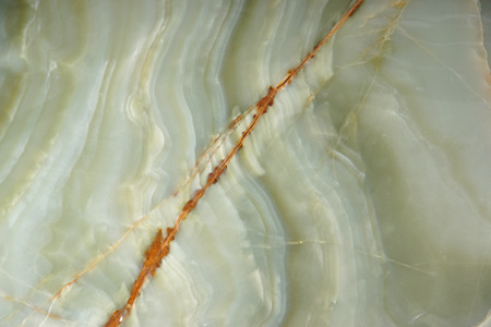 Natural green onyx stone with a red stripe on the surface.