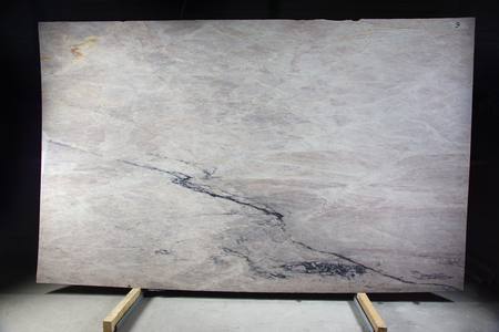 Natural stone of light color with streaks on a black background is called Saint Troupe.の写真素材