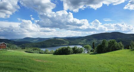 Journey to Norway, the fjord flows among hills covered with forests and green fields.の写真素材