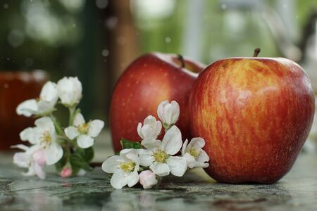 Still life with apples and delicate flowers on the table on a spring day.の写真素材