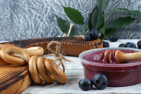 Whipped honey with blueberries and bagels on the table.の写真素材