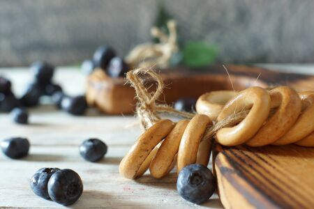 Blueberries and bagels tied with twine on the table.の写真素材
