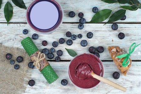 Blueberries on the table, next to whipped honey in a jar and copy space for your text and advertising, top view.の写真素材