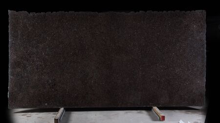 A large slab of natural stone of brown color with shiny blue sparkles called granite Labrador Antique.の写真素材