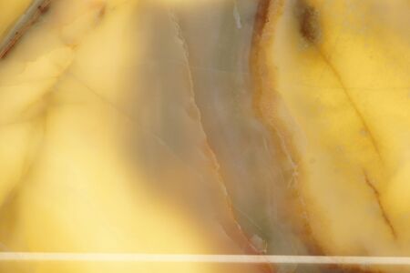 Polished yellow natural stone with a red pattern, backlit, called onyx.の写真素材