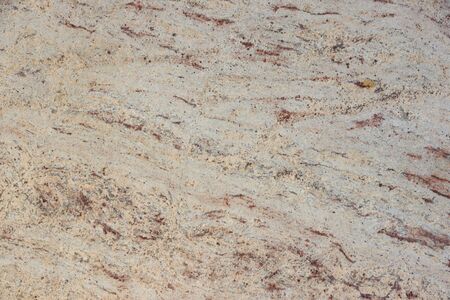 Background natural granite, beige with red dots, called Ivory Brown.の写真素材