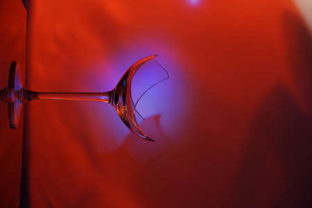 Broken wine glass, only the bottom on the leg remains, beautiful lighting.の写真素材