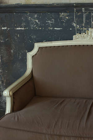 Part of a beautiful antique sofa that stands against the wall.の写真素材